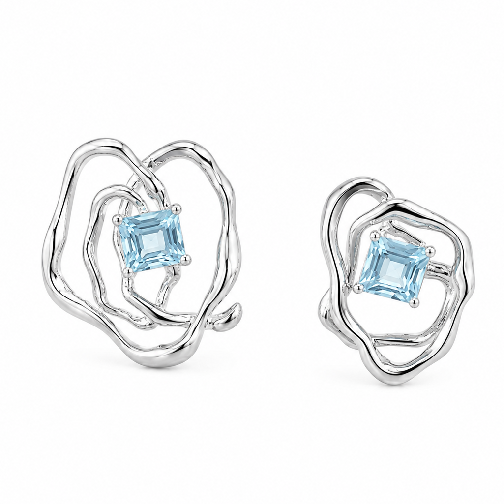 Silver-tone asymmetrical earrings with blue square gemstone in looping openwork design