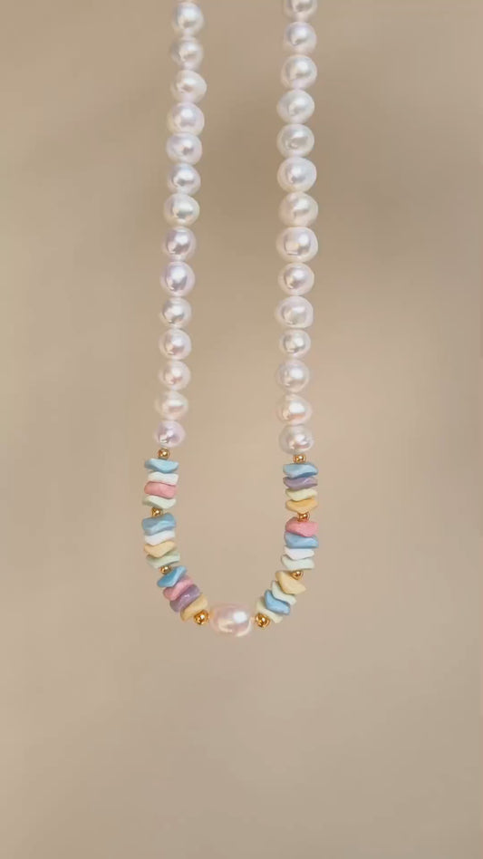 Freshwater pearl necklace with rainbow stone bead spacer links along the strands.