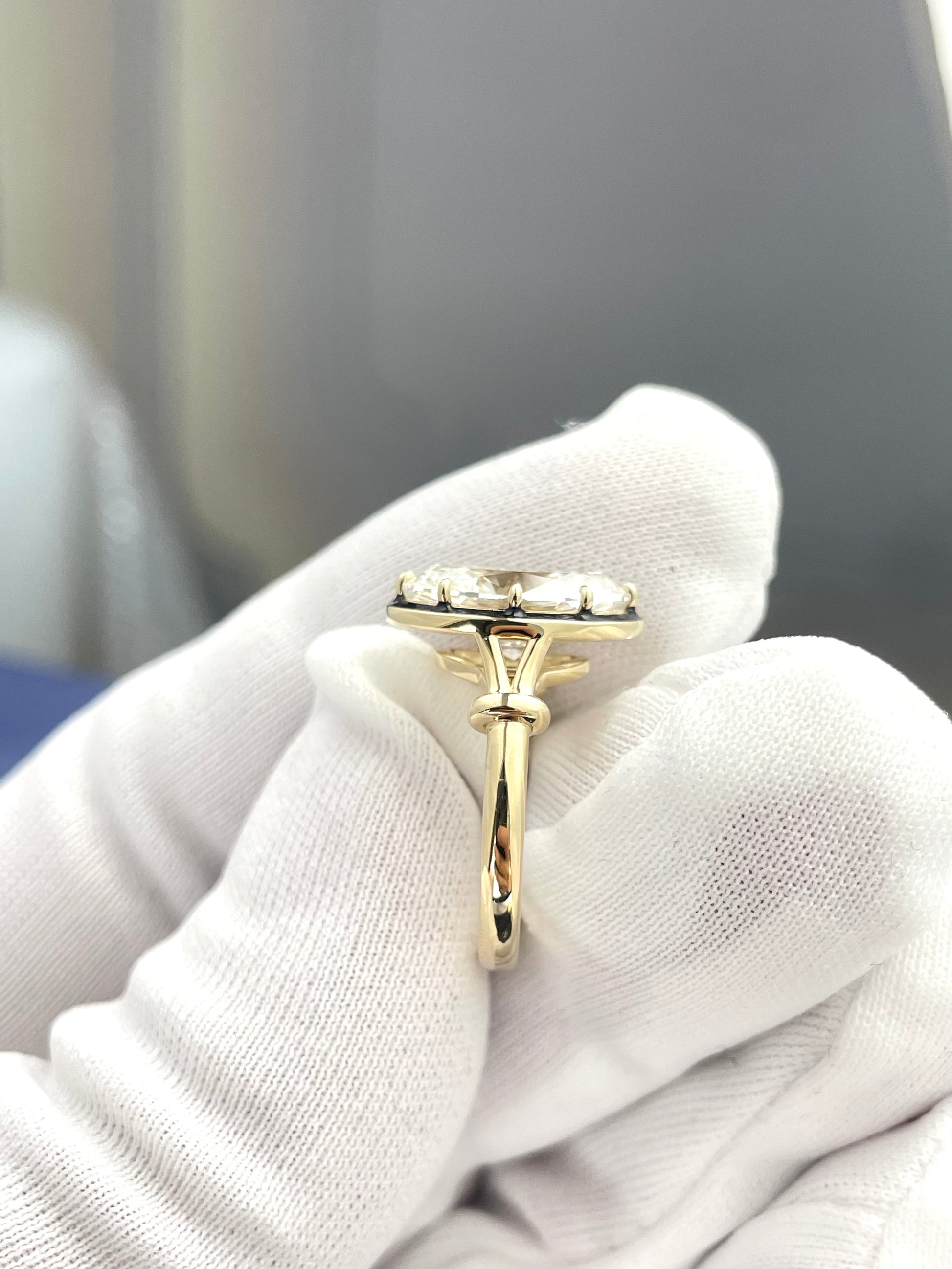 Oval lab diamond ring with small halo stones, slim gold band