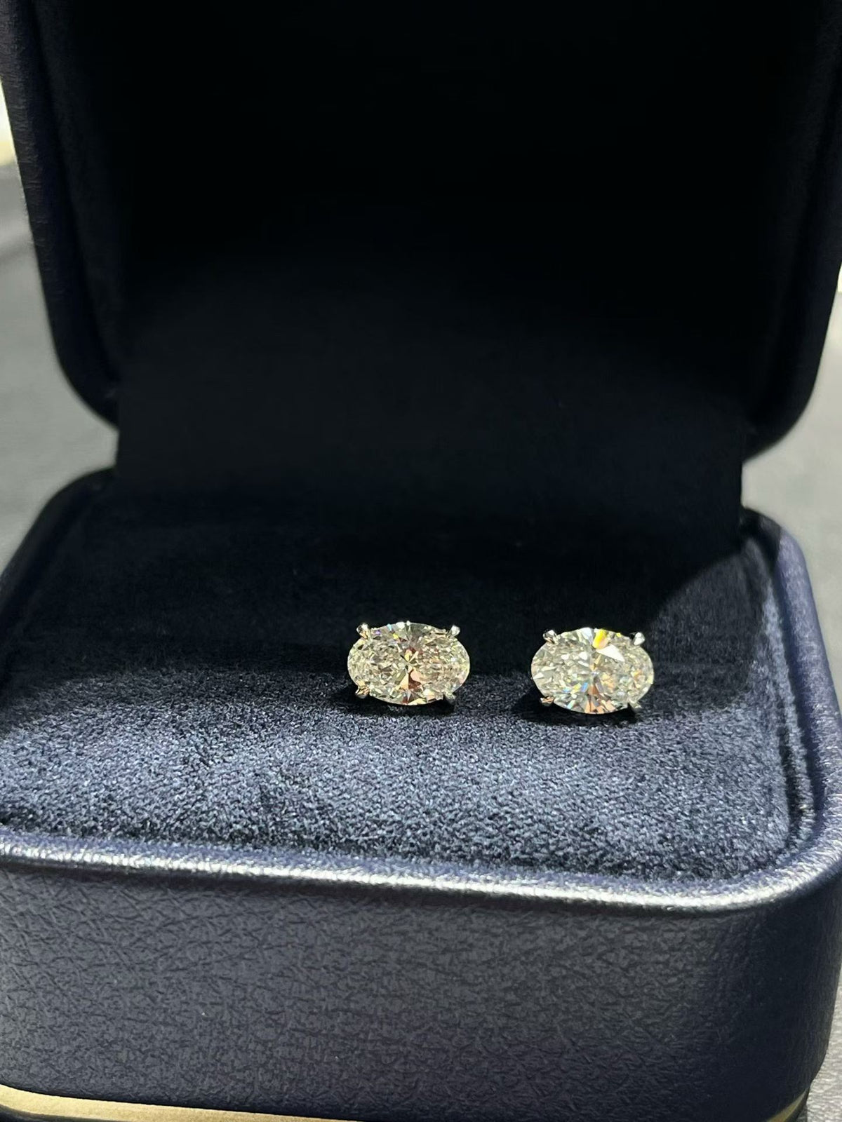 Oval lab diamond stud earrings in gold-tone bezels, pair