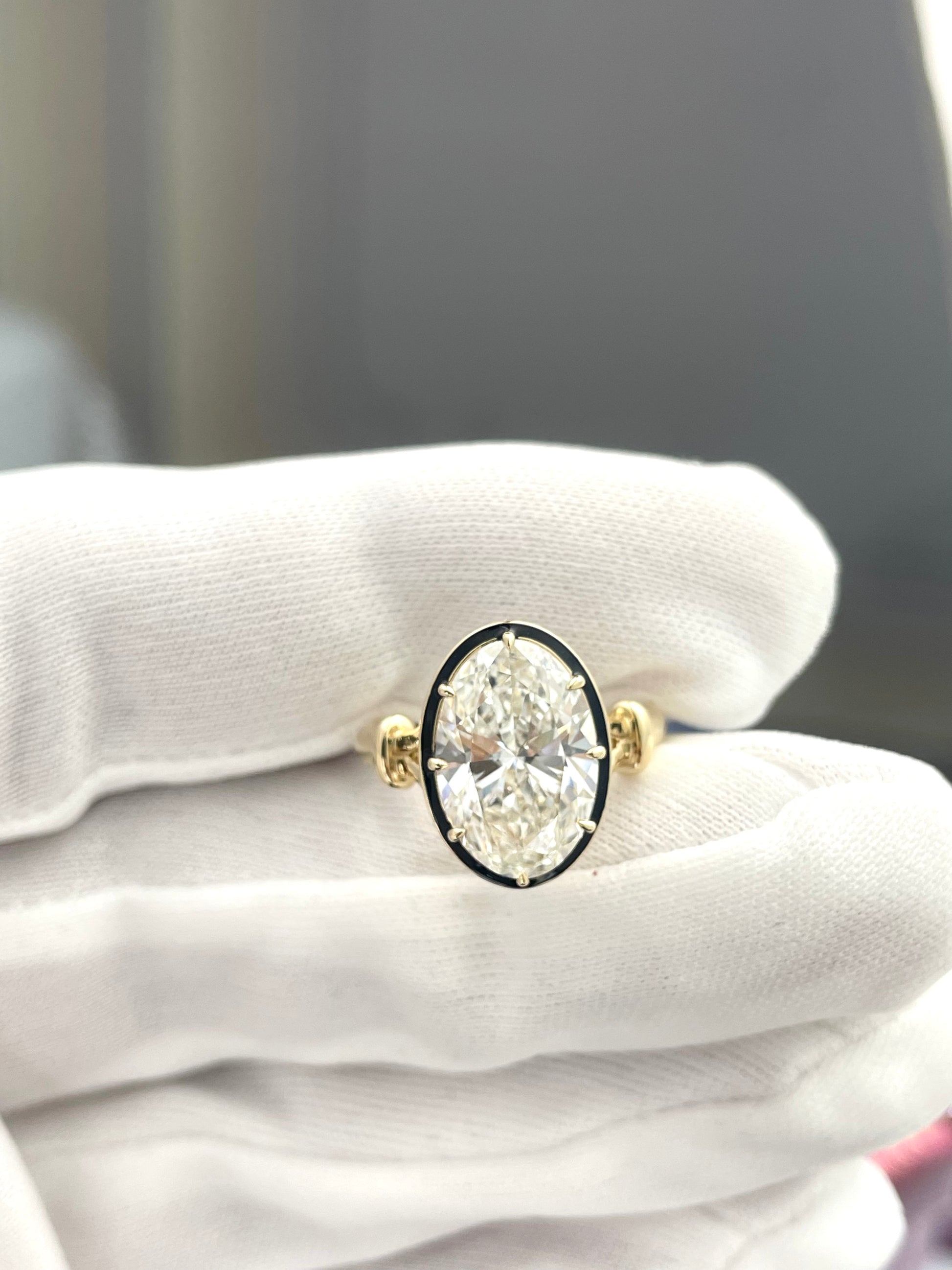 Oval lab diamond ring with round halo and gold shoulders, prong-set center