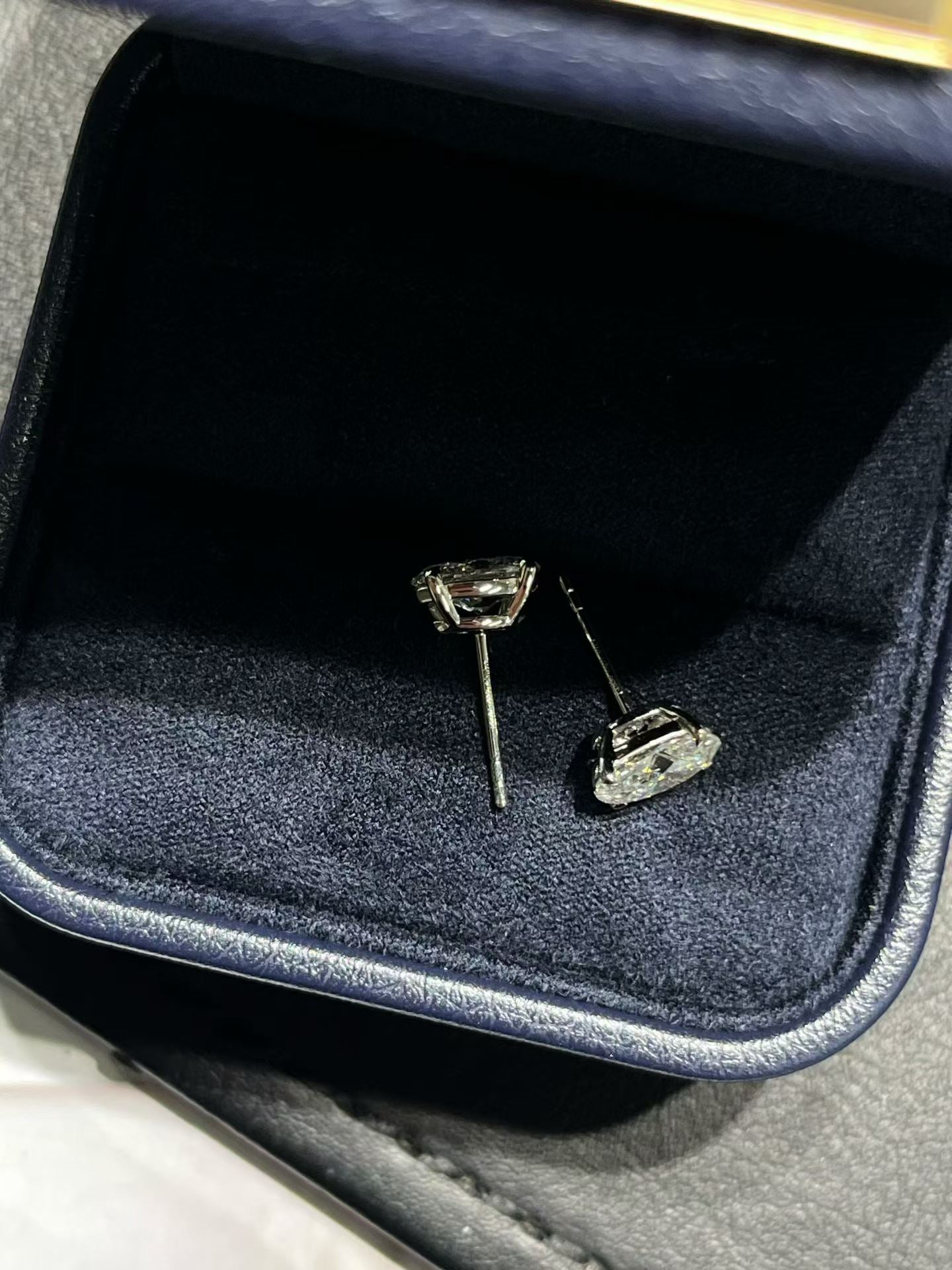 Oval lab diamond stud earrings with gold-tone prong settings