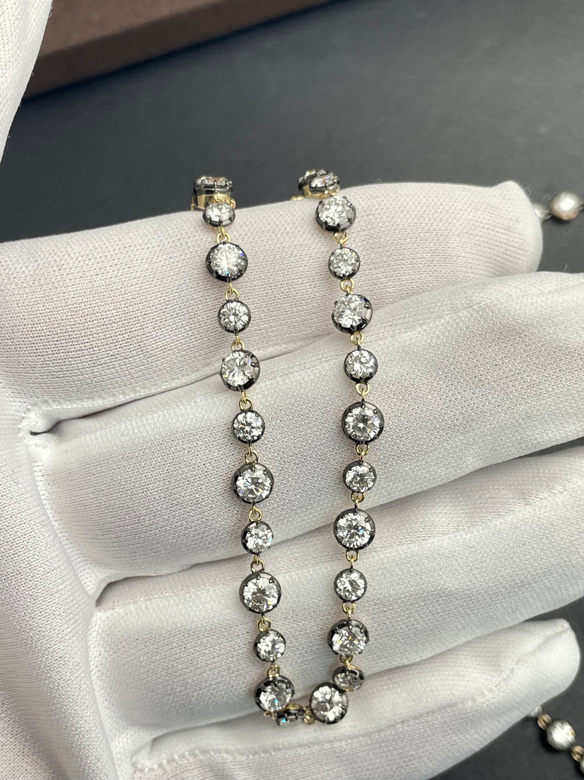Gold-tone diamond tennis bracelet on glove, linked round stones and clasp end