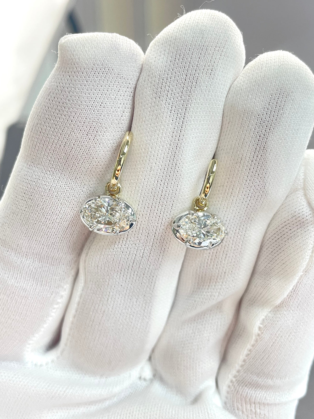 Gold-tone drop earrings with clear crystal teardrop and small halo stones