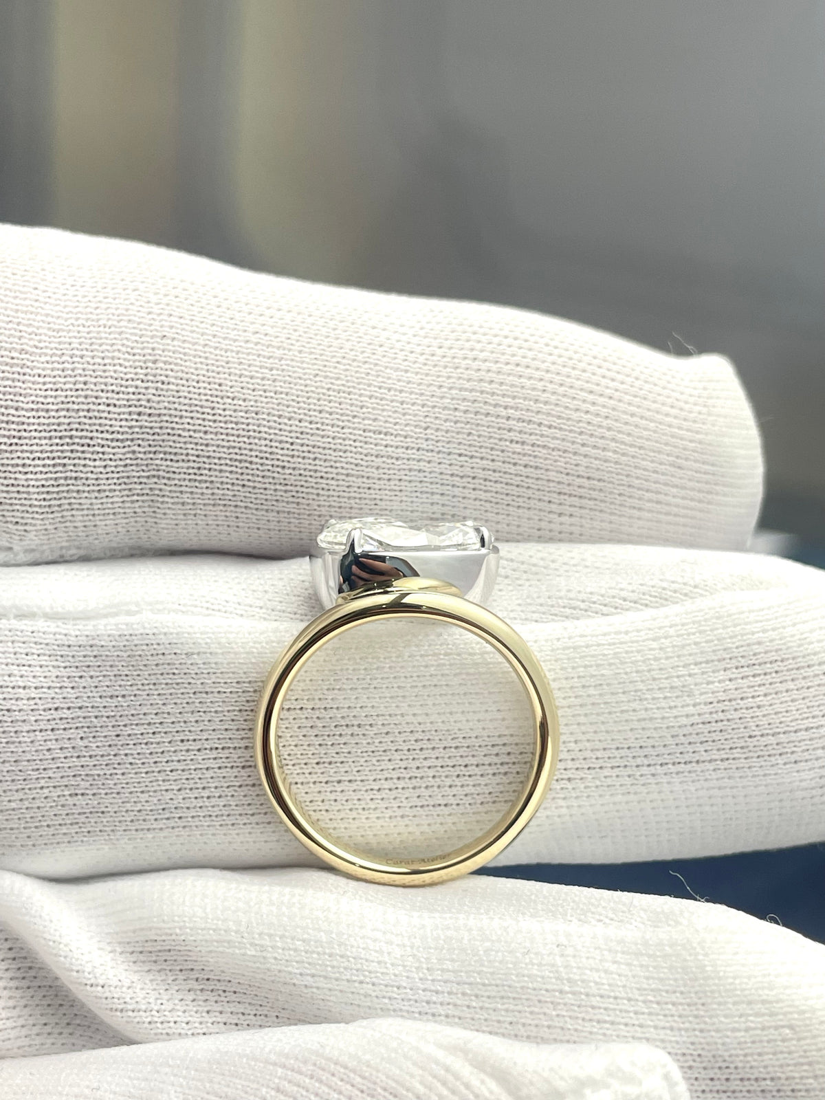 Floating oval lab-grown diamond ring, yellow gold band with elevated clear stone