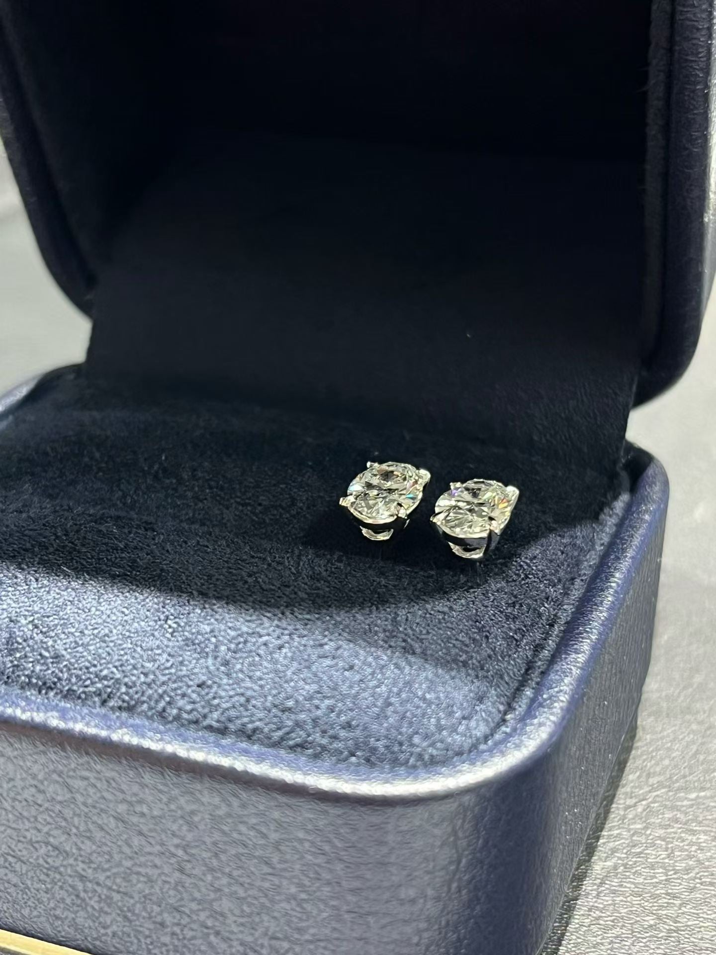 Oval lab diamond stud earrings, gold-tone settings, close view