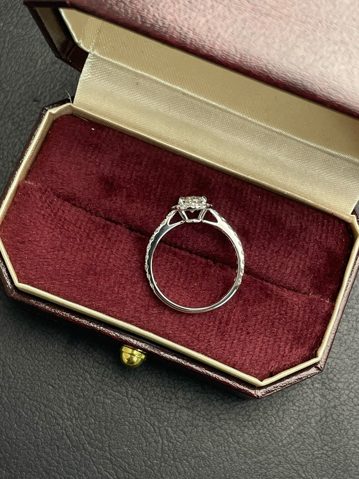 Oval lab diamond halo ring in silver-tone metal, oval center stone, ring box view
