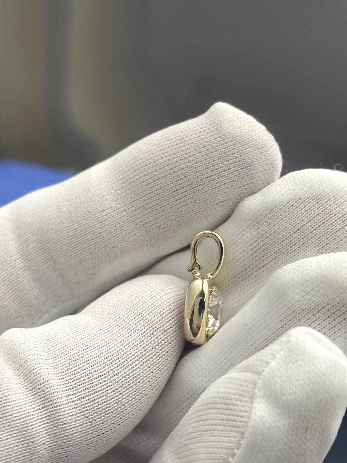 Round lab diamond pendant in gold tone, side view with loop bail